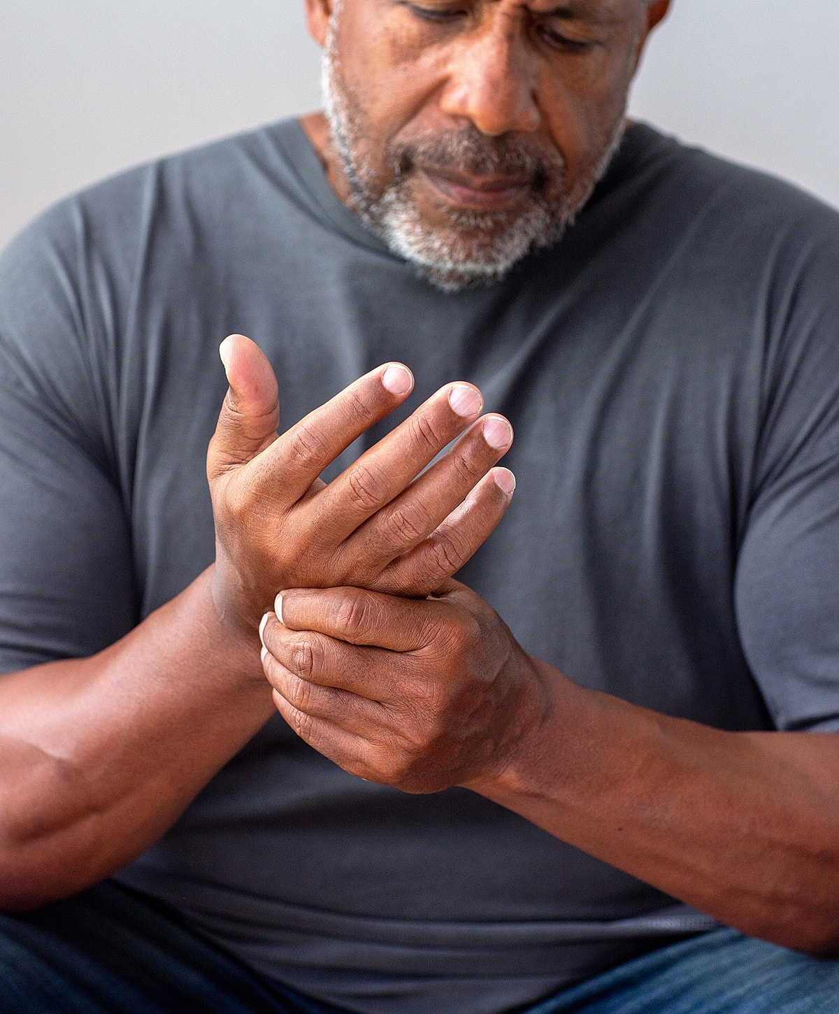 Man holding his wrist in discomfort.